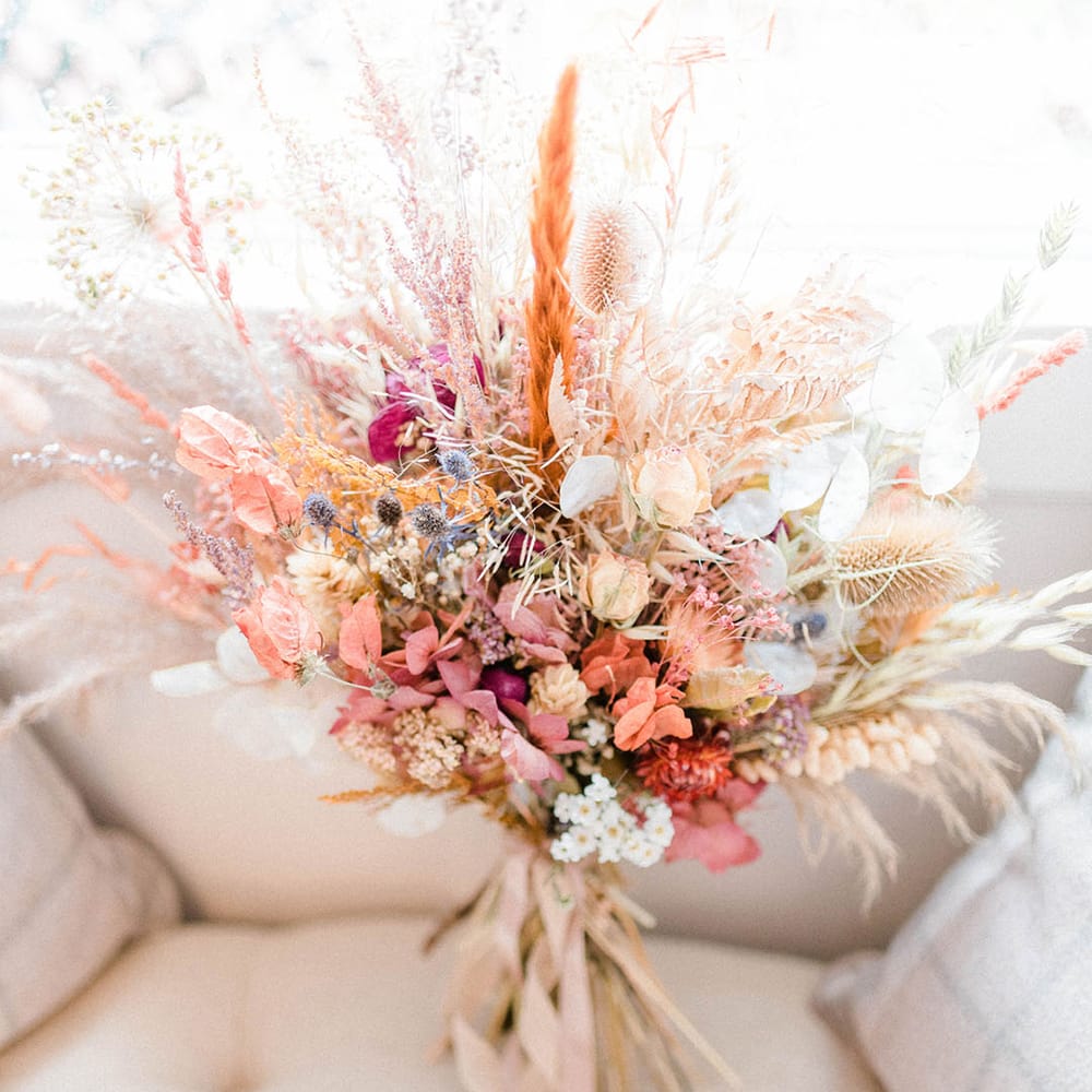 Dried floral arrangement for bridal bouquet complete with pampas grass and tied with silk ribbon 