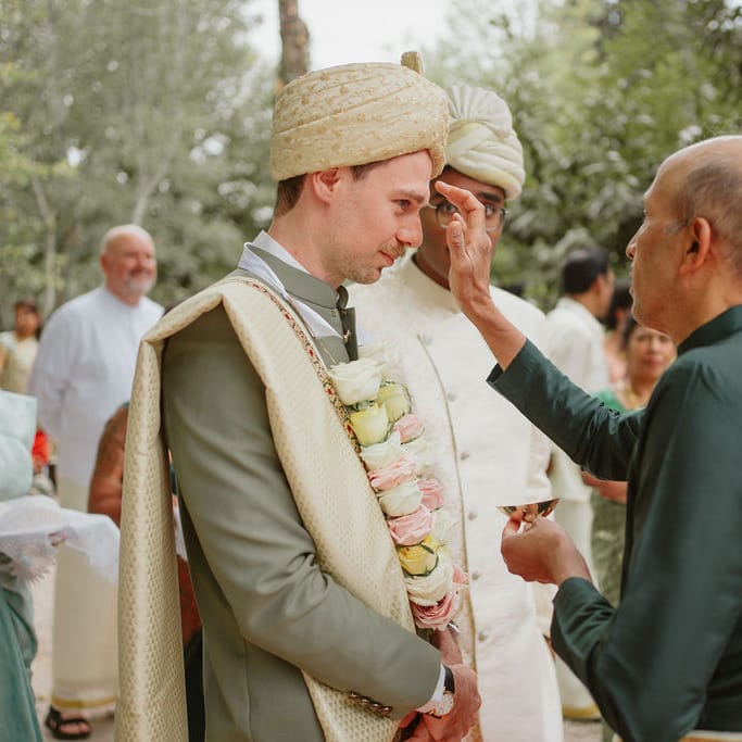 Groom in a green Sherwani at Domaine de Blanche Fleur Provence wedding