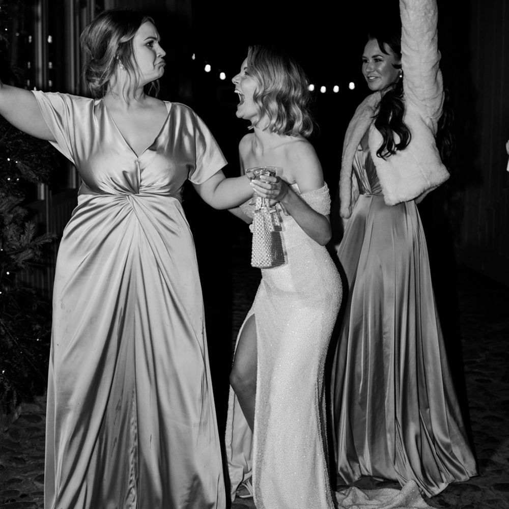 The bride dances with some of her bridesmaids in gold satin bridesmaid dresses at the Wyresdale Park wedding 