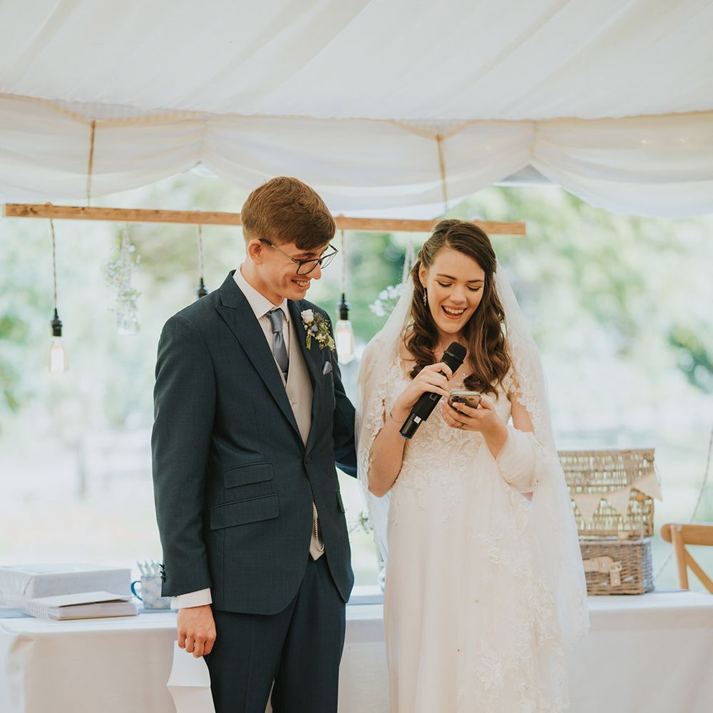 The bride and groom perform a joint wedding speech together for their wedding reception 
