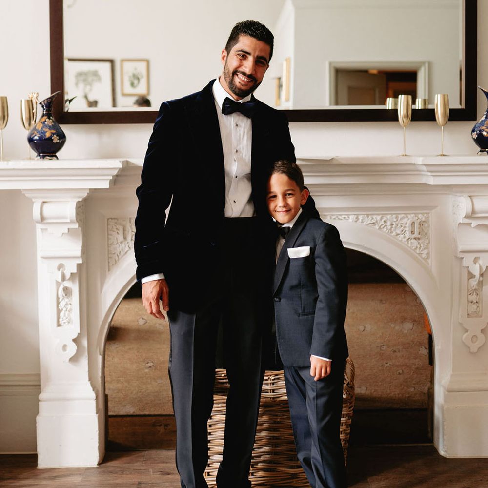 Groom in black tie with the page boy in black tie outfit 