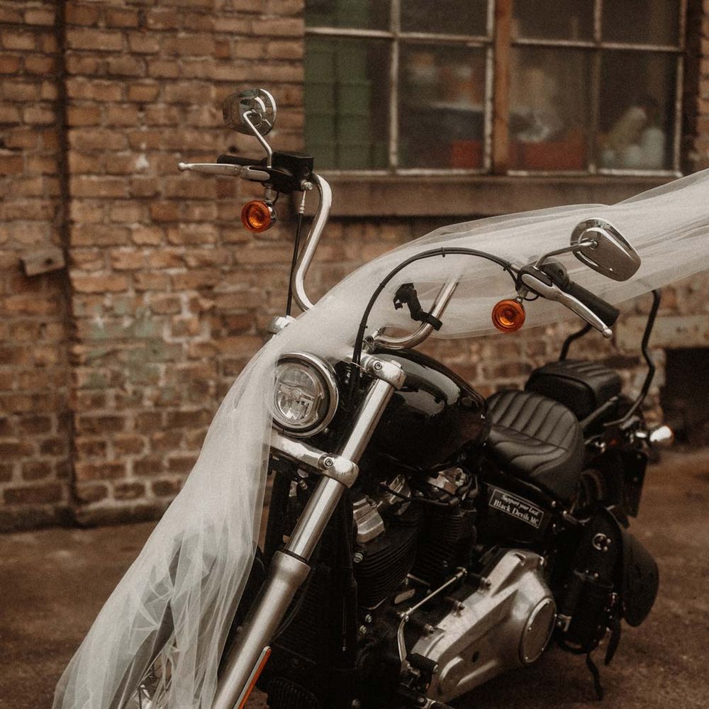 Wedding motorbike with church length wedding veil over the top of it 