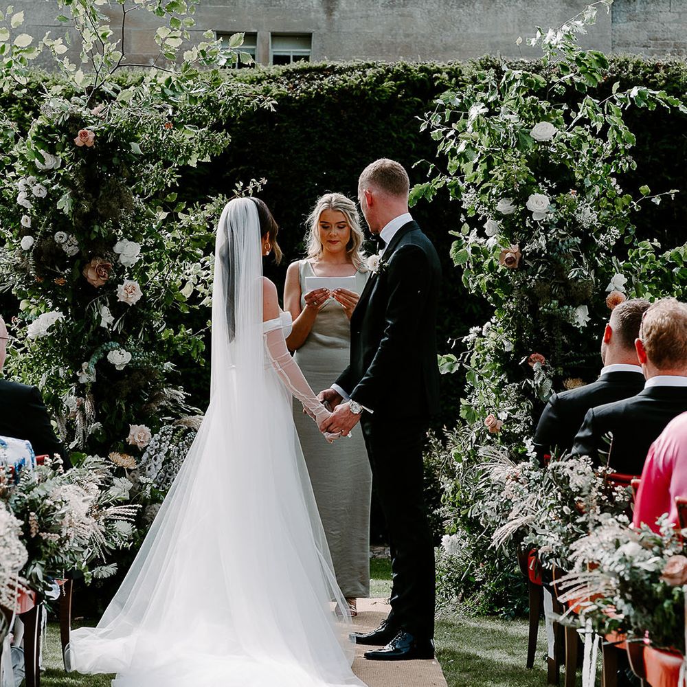 Bride wearing Aleena Lena wedding gown standing with groom at the outdoor ceremony 