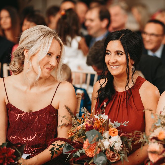 Bridesmaids in different rust coloured dresses at Millbridge Court wedding