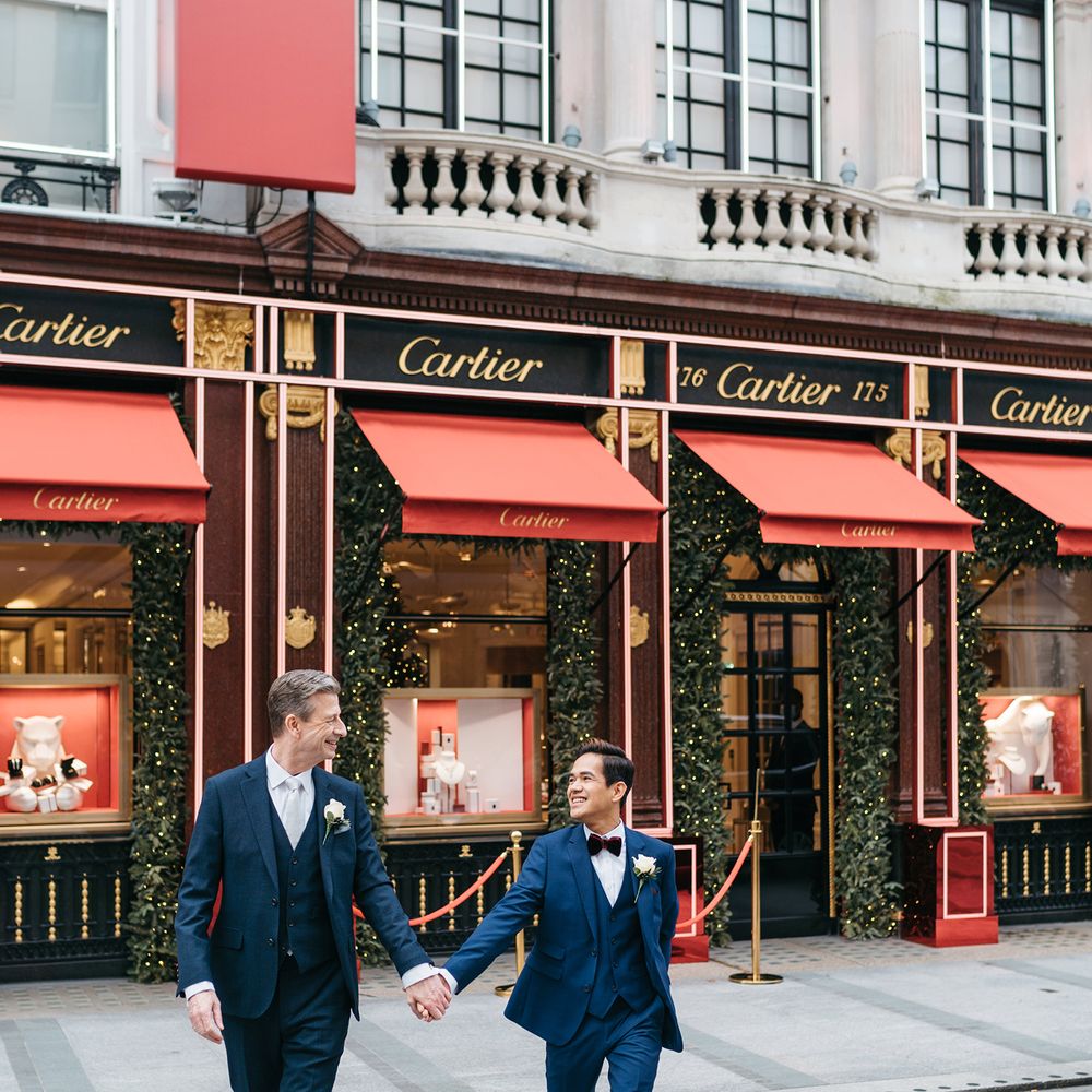 Grooms walk through London before wedding ceremony 