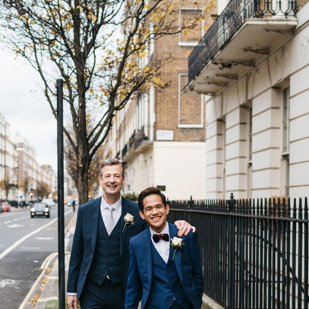 Groom puts his arm around fiancé on the morning of wedding