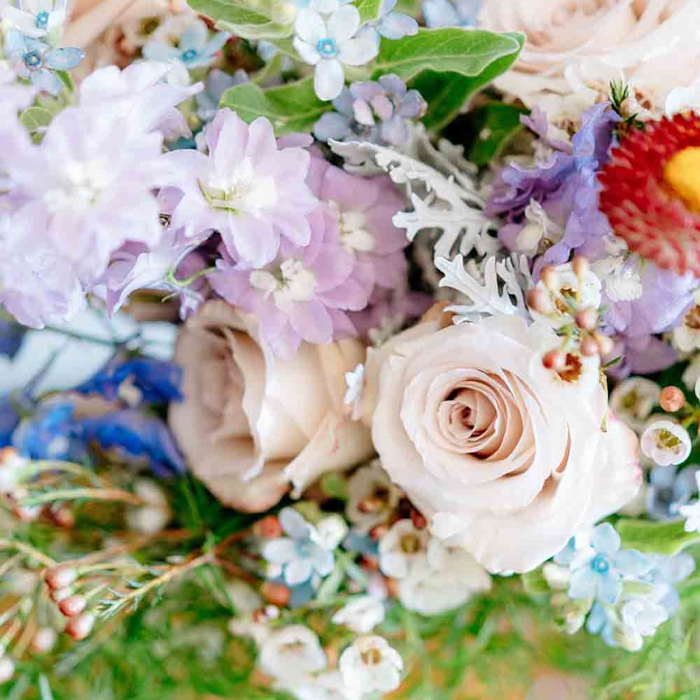 Beautiful wedding bouquet with roses and wildflowers