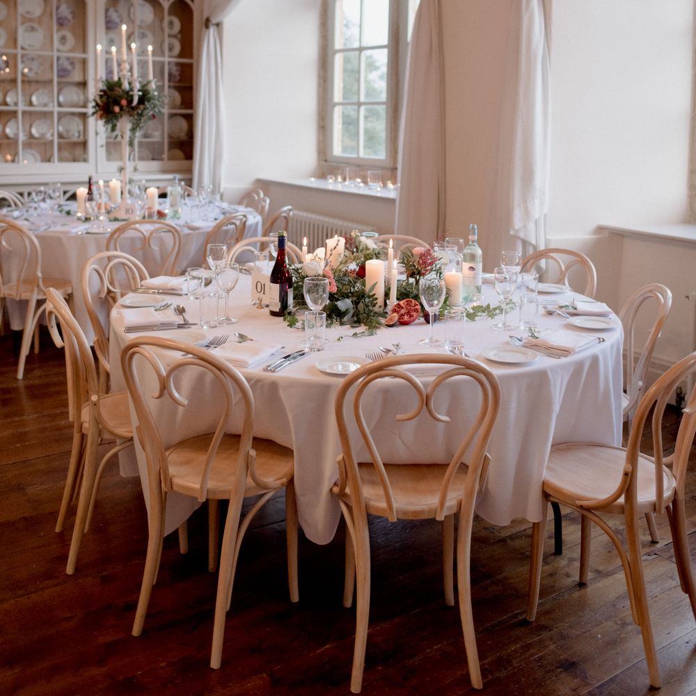 White and green wedding table decor with pomegranate with red and white wine 