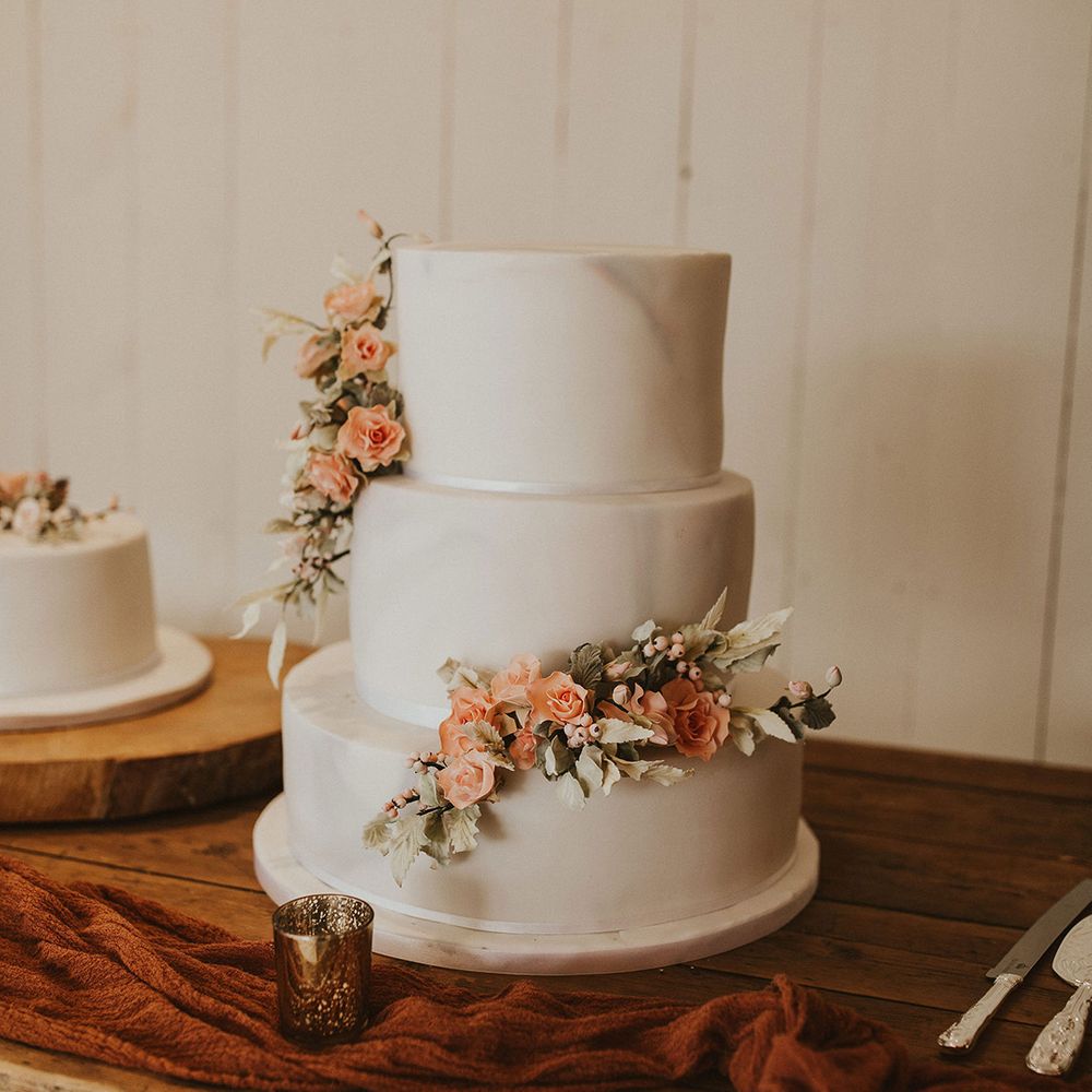 Marble wedding cake with peach flower decor