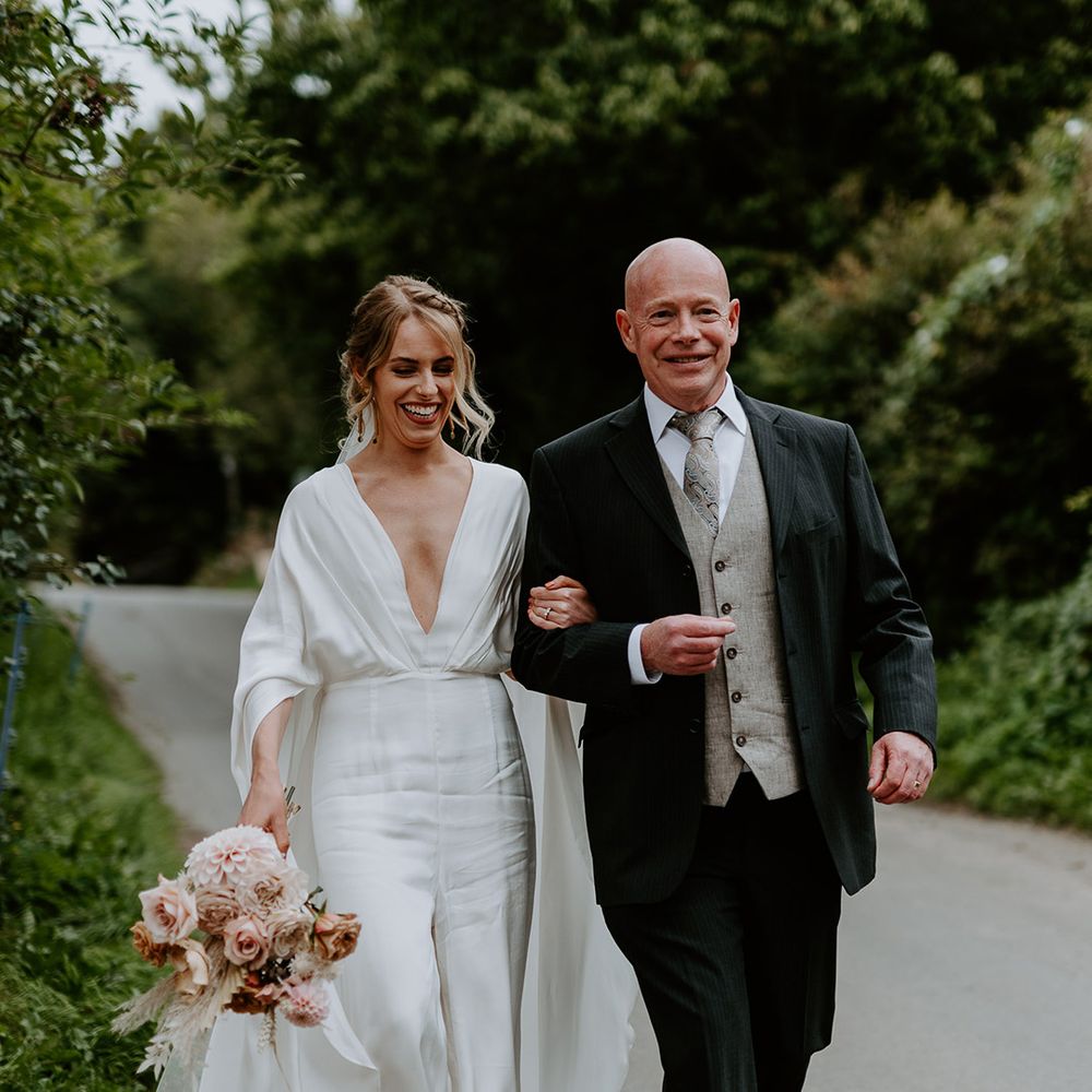Bride walks with her father on her wedding day