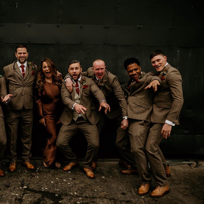 groomsmen and woman in brown beige suits and satin dress at Lyde Court autumn wedding 