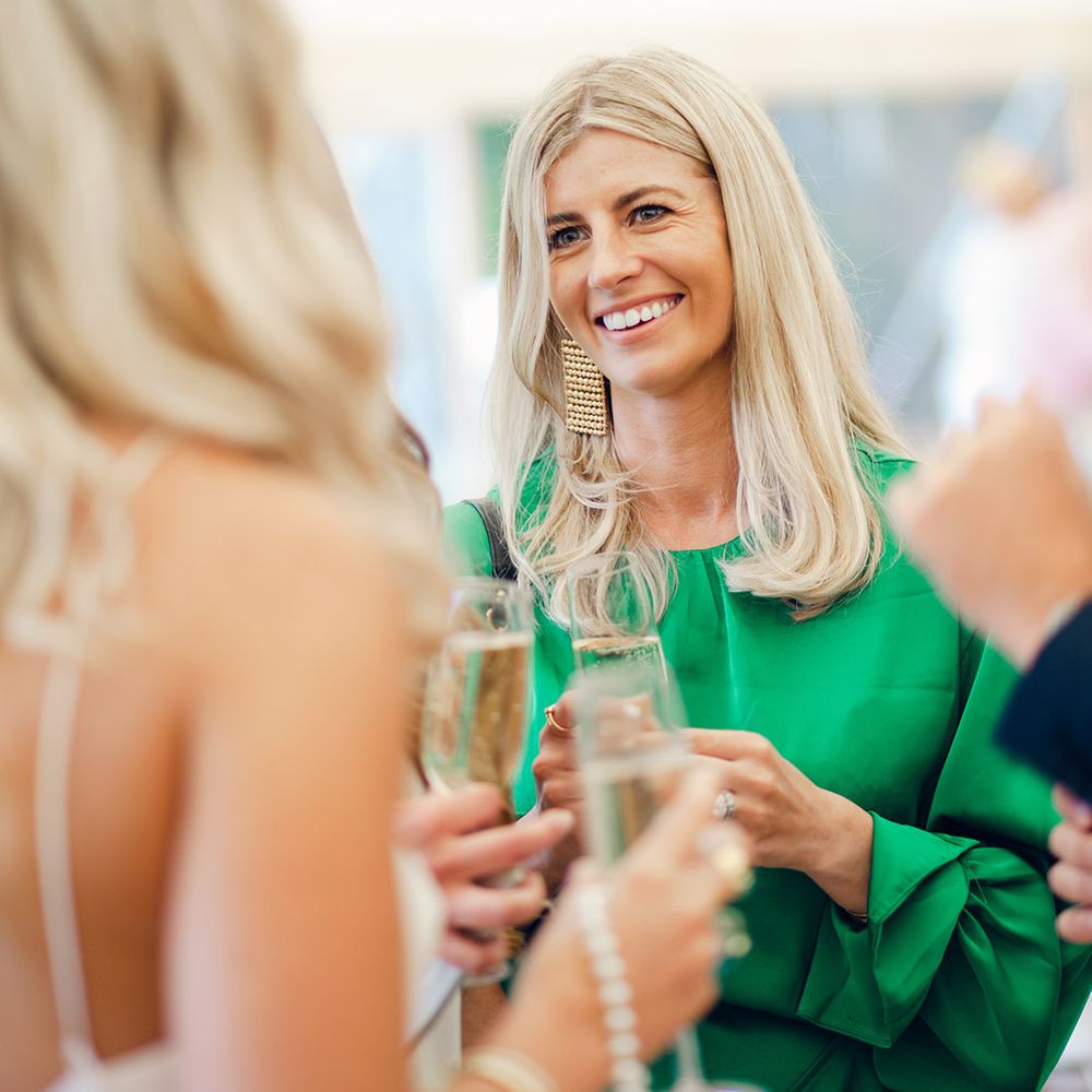 Wedding guest in green dress with gold earring