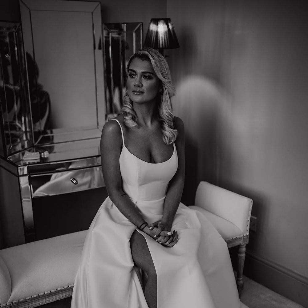 Bride in a princess wedding dress with spaghetti straps and front slit 