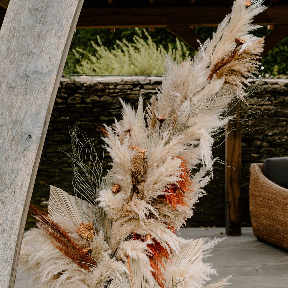 Pampas grass and dried palm leaves flower column for the altar decoration 