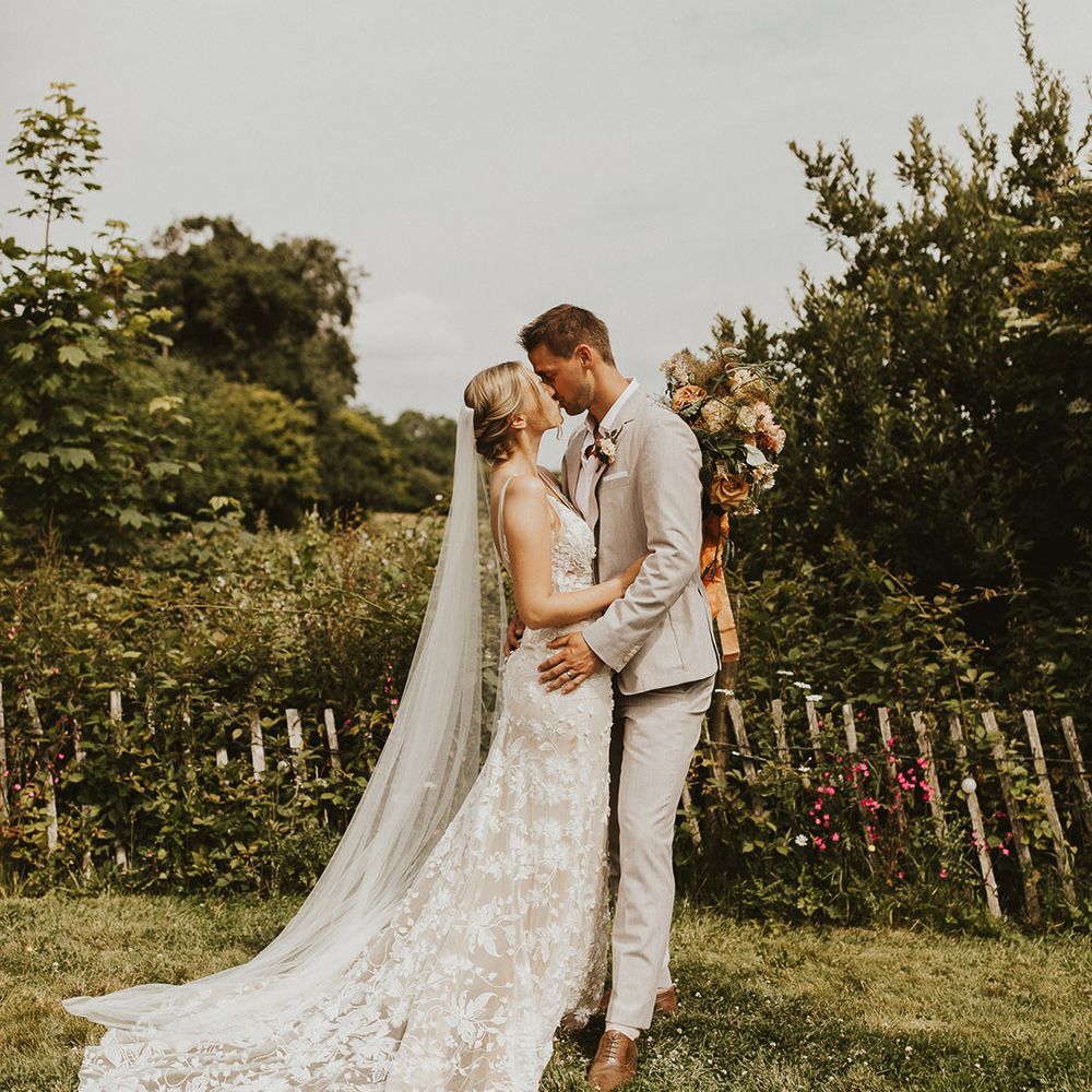 Bride and groom share a kiss on their wedding day at Nancarrow Farm 