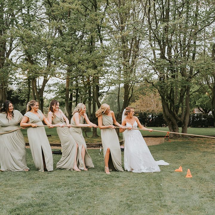 The groom plays tug of war against the bride and her bridal party