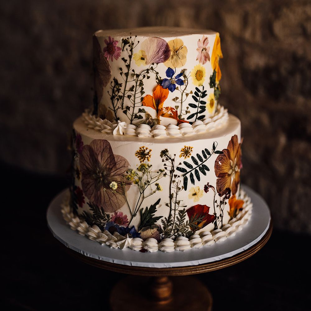 Two tier white iced pressed flower wedding cake 
