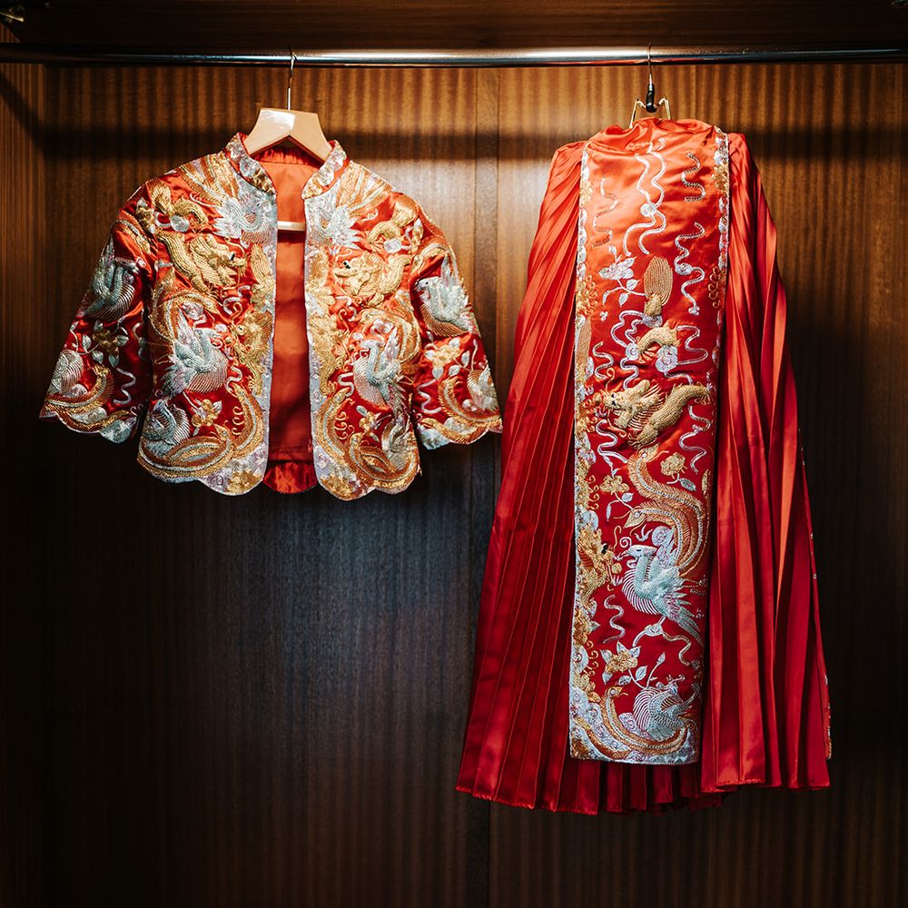 Bridal gown with intricate design and red and gold colouring 