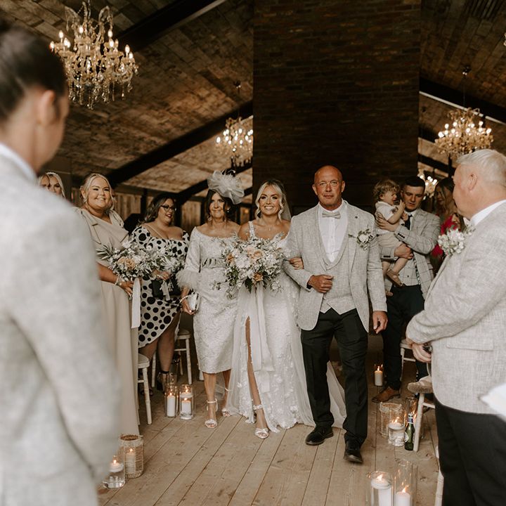 Father of the bride in three piece matching light grey suit was the bride down the aisle for the rustic luxe wedding at Hidden River Cabins 