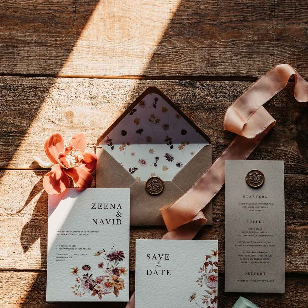 Botanical luxe wedding stationery with minimalistic tones and font, dainty floral decorations and light orange ribbon 