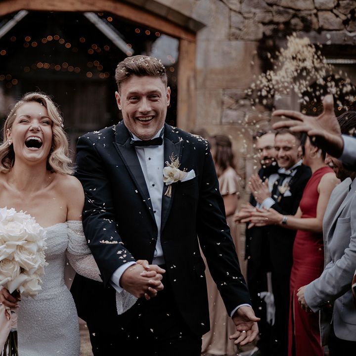 Confetti moment for the bride and groom as they exit from their bespoke wedding ceremony at Wyresdale Park wedding venue 
