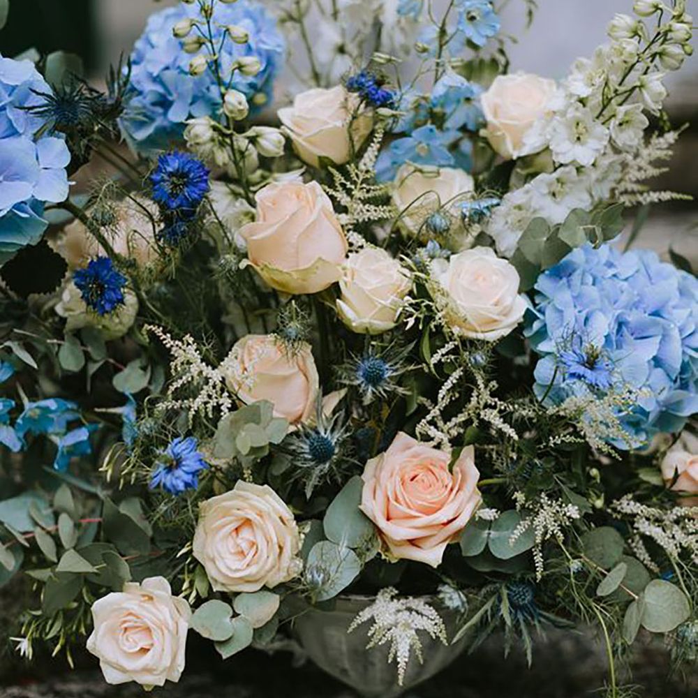 Blue wedding flowers with soft peach and creams accents by Thomas Steibl Photography 