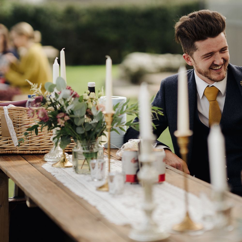 Wedding guest laughs at the bar 