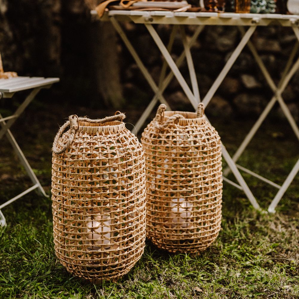 Wicker candle holders in outdoor reception setting
