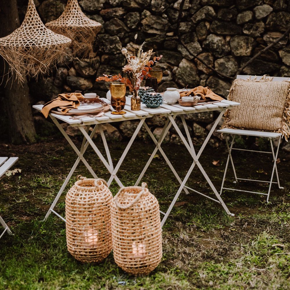 White wooden table complete with rustic table setting