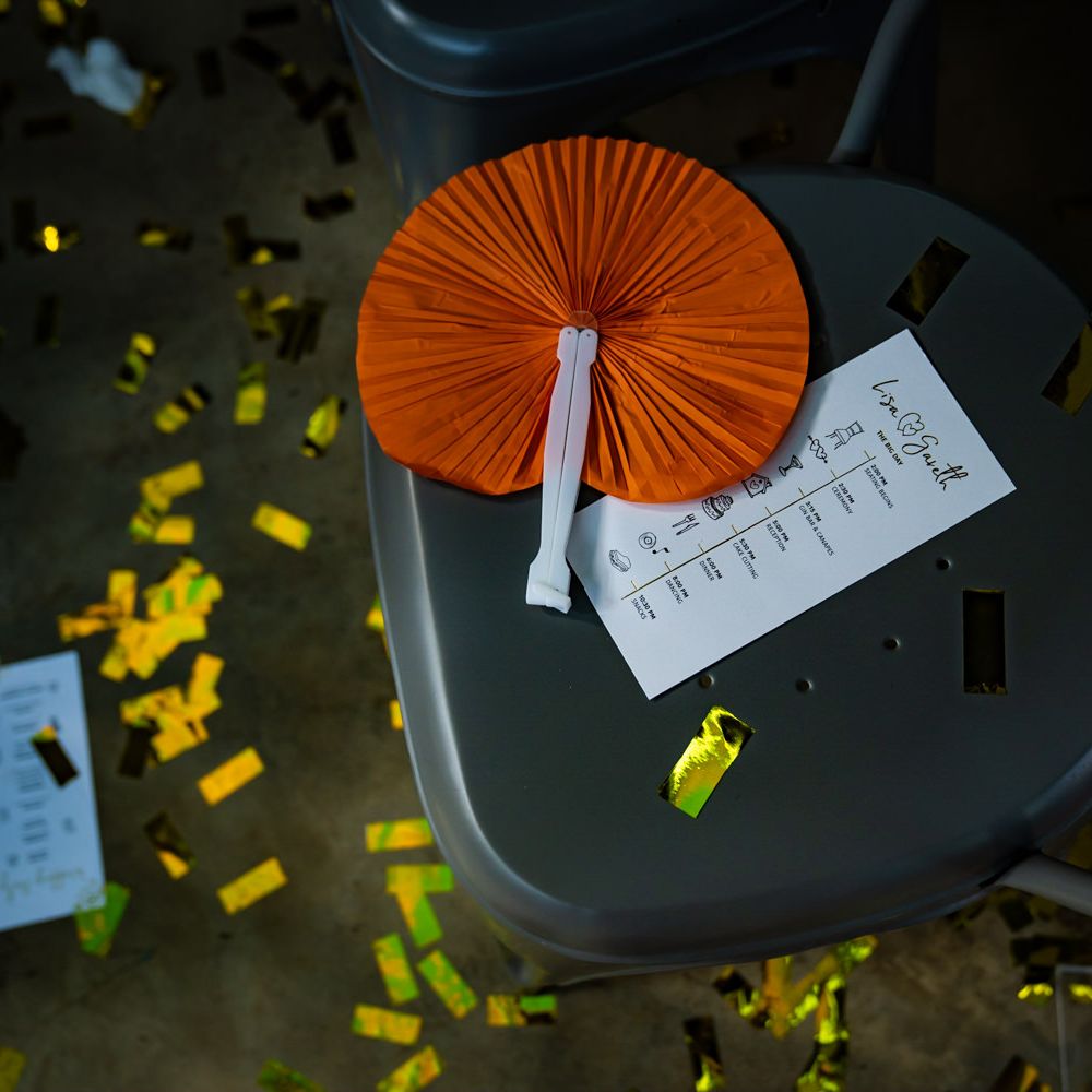 Bright paper fan on guests chair with order of the day
