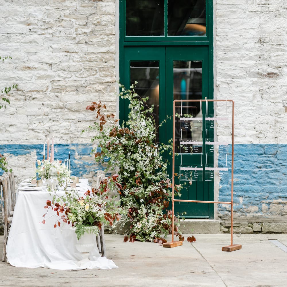 Intimate Torr Vale Mill wedding reception with botanical flowers, acrylic signs and taper candles 
