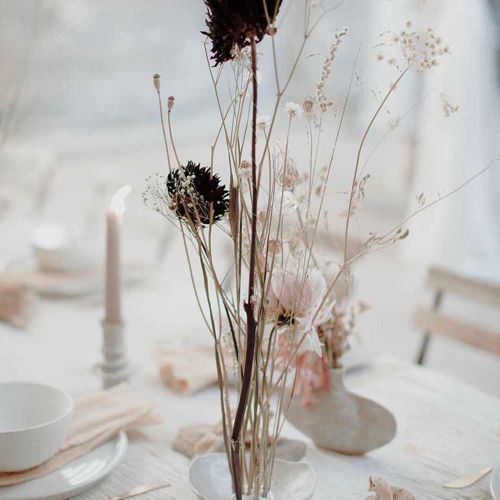 dried wedding flower stems in ceramic finger bowls 