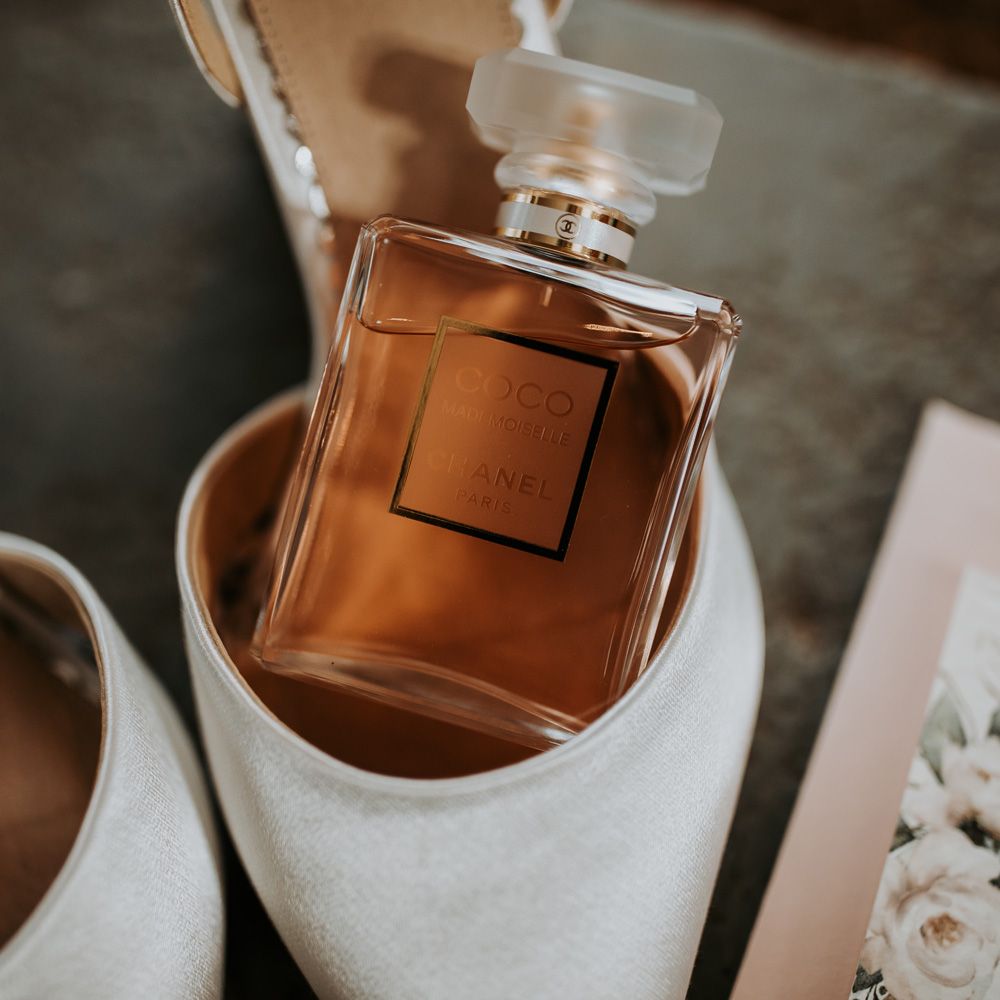 Chanel perfume bottle in white wedding shoe for barn wedding