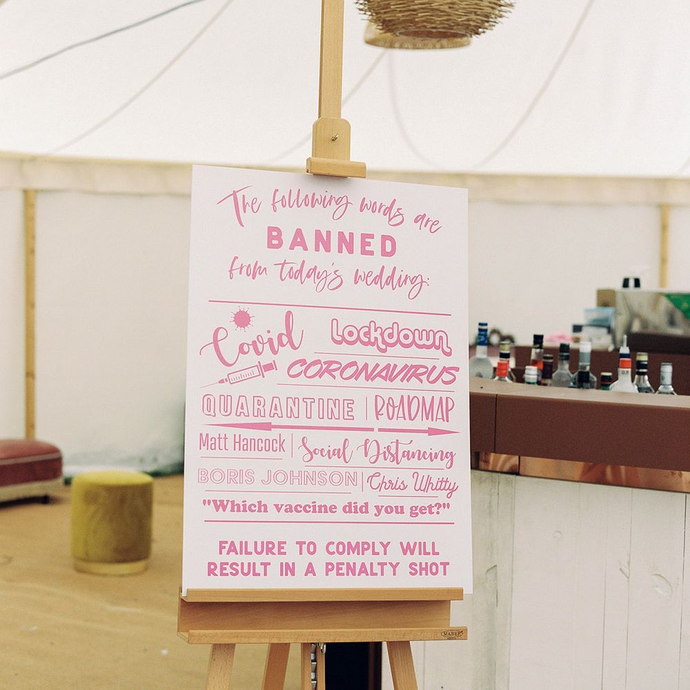 Fun pink wedding sign at marquee wedding
