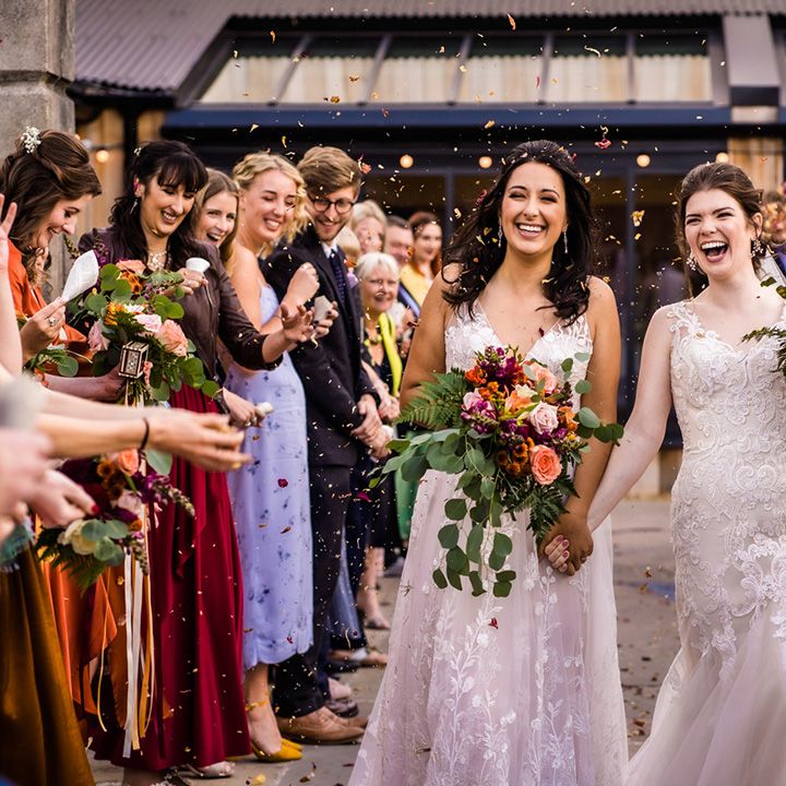 Brides have their confetti exit as wedding guests throw autumnal dried flower confetti 