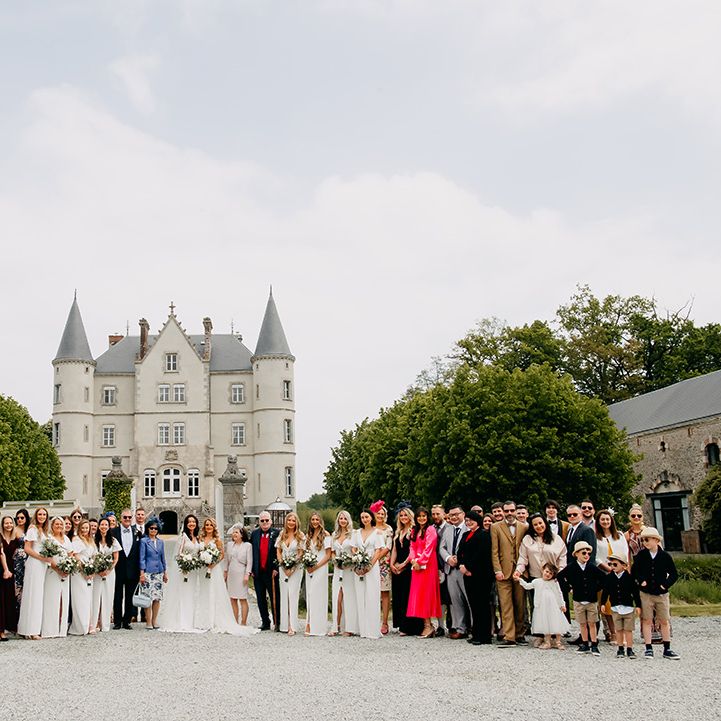 Entire wedding party get a photo together for lgbtqi+ wedding at the chateau 
