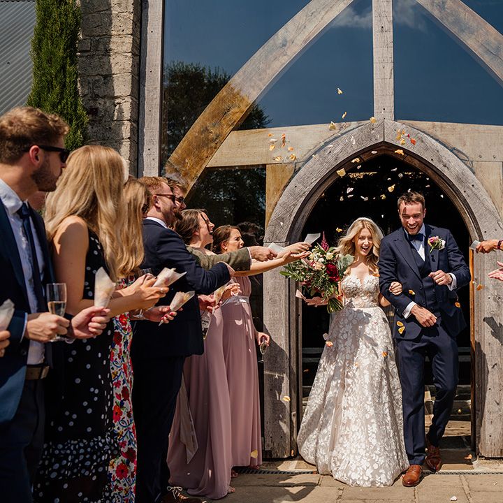 Bride and groom exit their wedding ceremony to rose petal confetti 