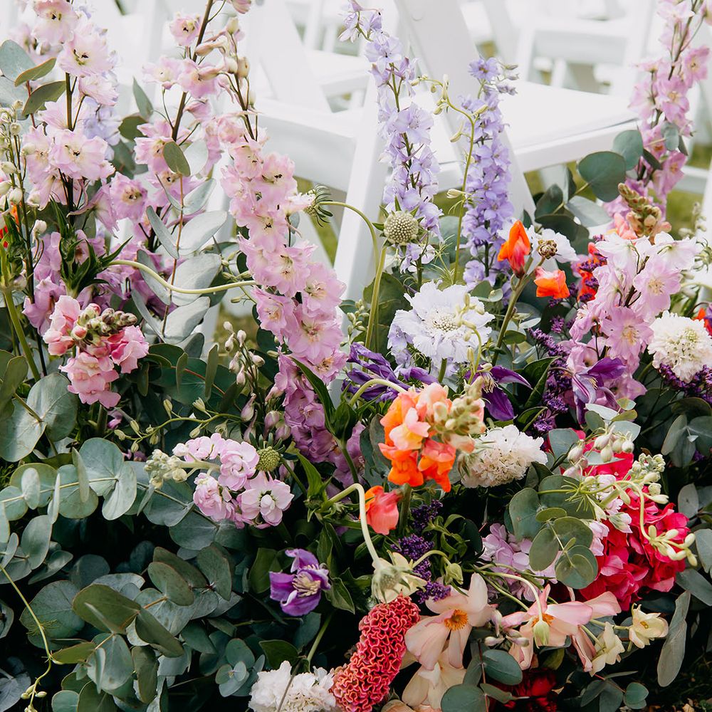 Vibrant wedding flower decoration for the aisle with wildflowers for summer wedding 