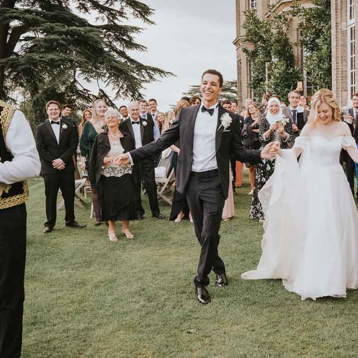 Bride in off the shoulder princess dress and groom in classic tux dancing at Hedsor House - how to say no kids at wedding 