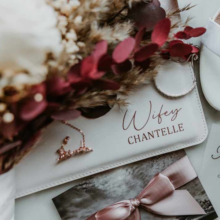 Boho wedding stationery in white and dusky pink with personalised embossed white wallet 