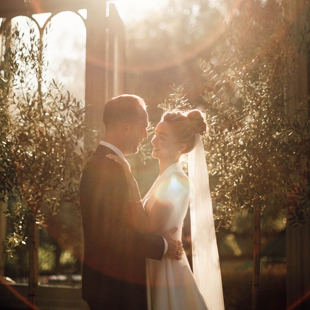 Golden hour wedding photo of the bride and groom at their classic country house wedding 