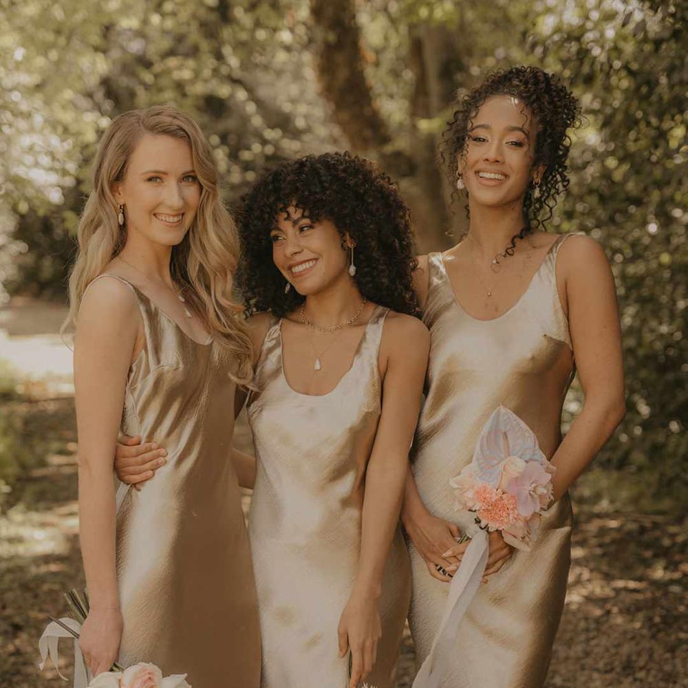 Bridesmaids wearing slip satin gold bridesmaid dresses - hen party ideas