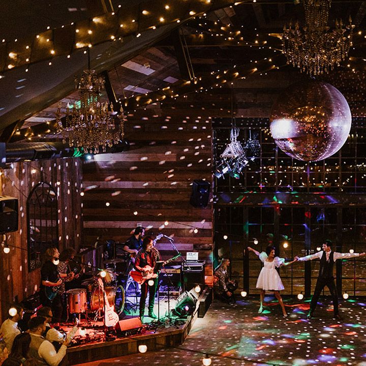 The bride and groom dance their choreographed routine under colourful lights at Wharfedale Grange wedding venue 