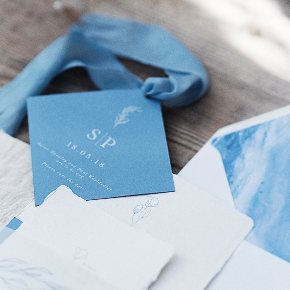 Blue and white wedding stationery flatlay 