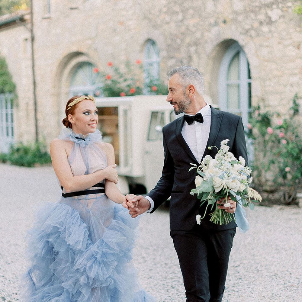 Something blue wedding idea with bride in blue wedding dress with groom in tuxedo 