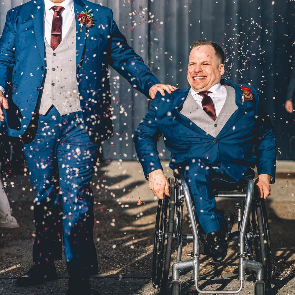 Two grooms wearing matching dark navy wedding suits for their LGBTQI gay wedding 