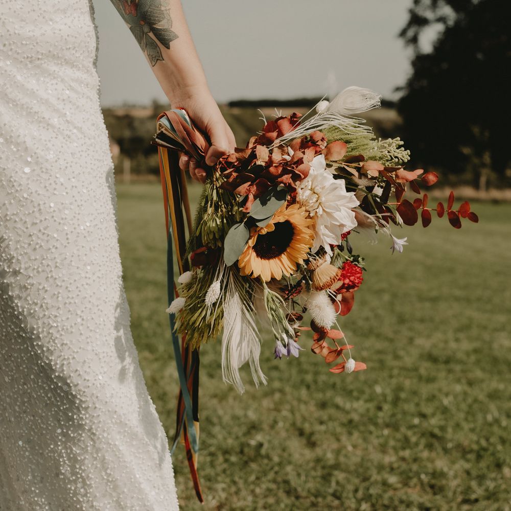 Wedding bouquet with sun flowers and wild flowers 