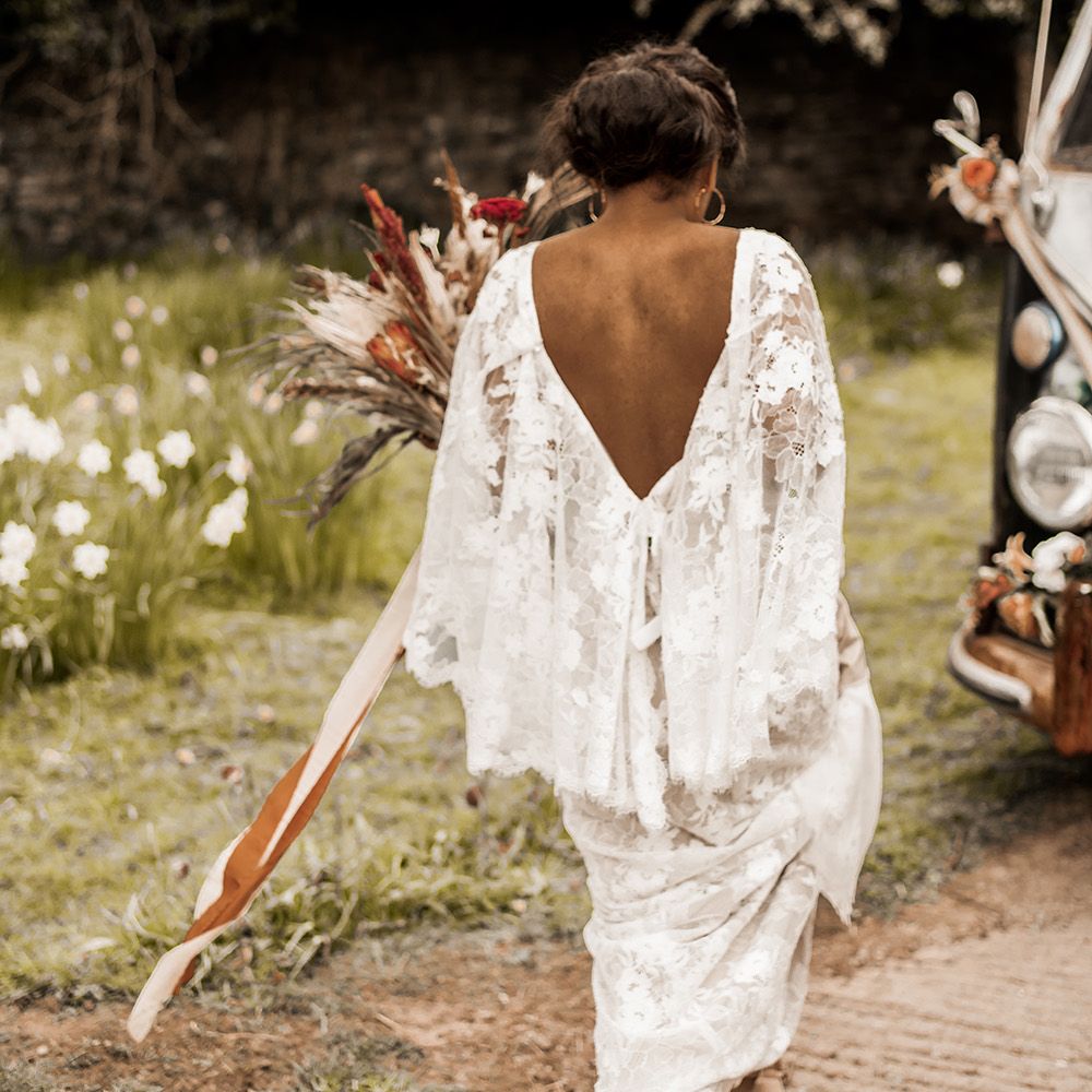 Indian bride in a boho wedding dress with lace batwing sleeve detail 