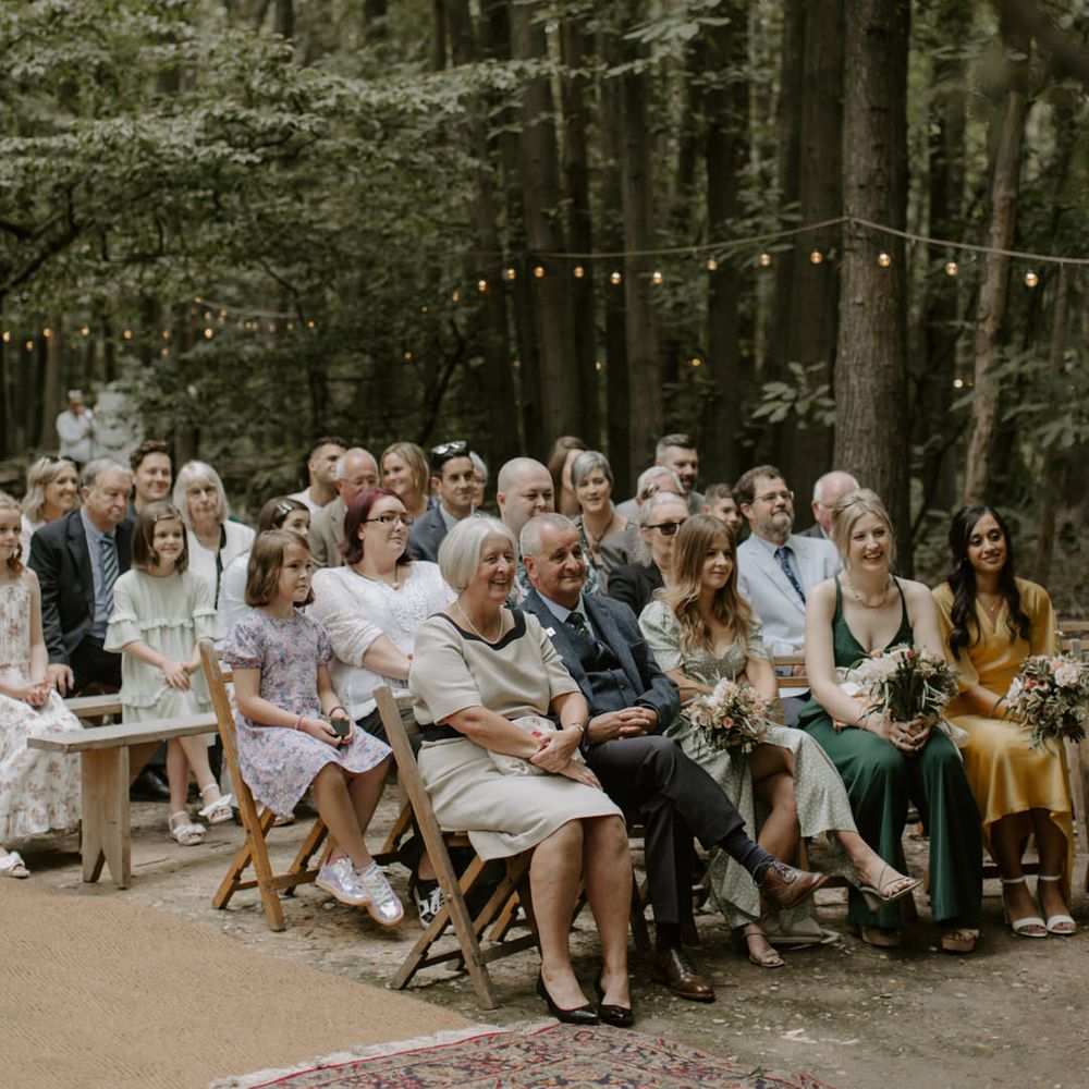 Wedding guests watch on during ceremony at The Dreys