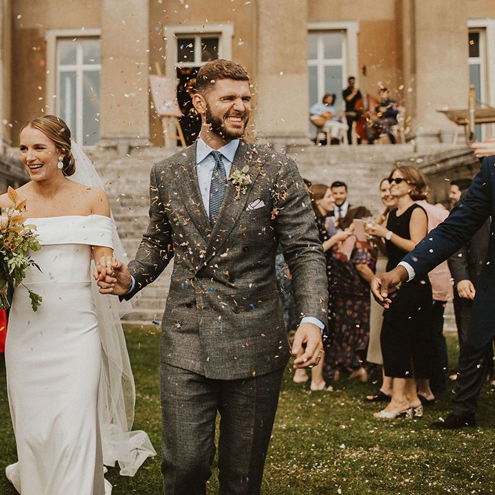 Bride & groom walk through confetti on their wedding day